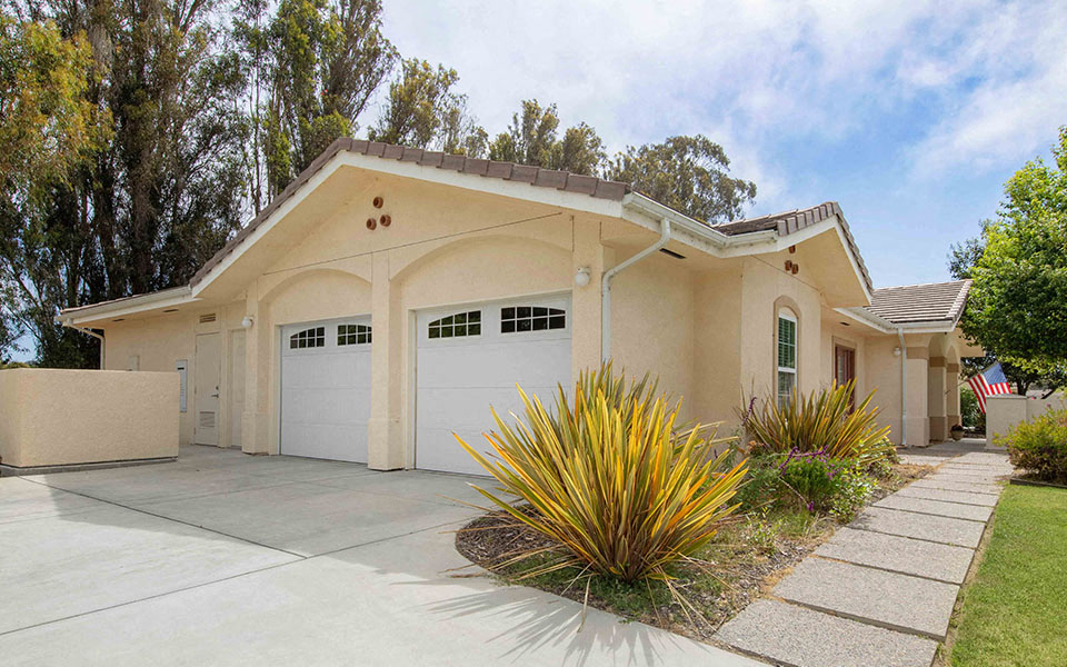 a house with two garage doors and a driveway