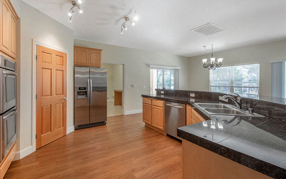 a kitchen with granite counter tops and stainless steel appliances