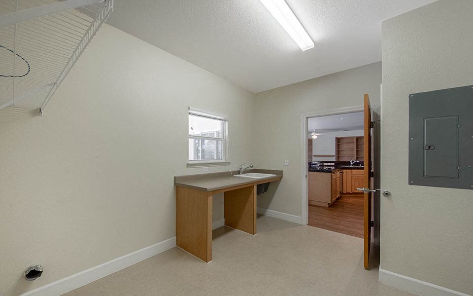a kitchen with a sink and a counter in a room