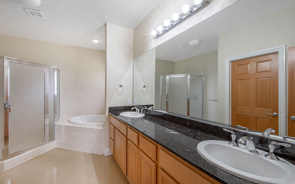 a bathroom with two sinks and a large mirror