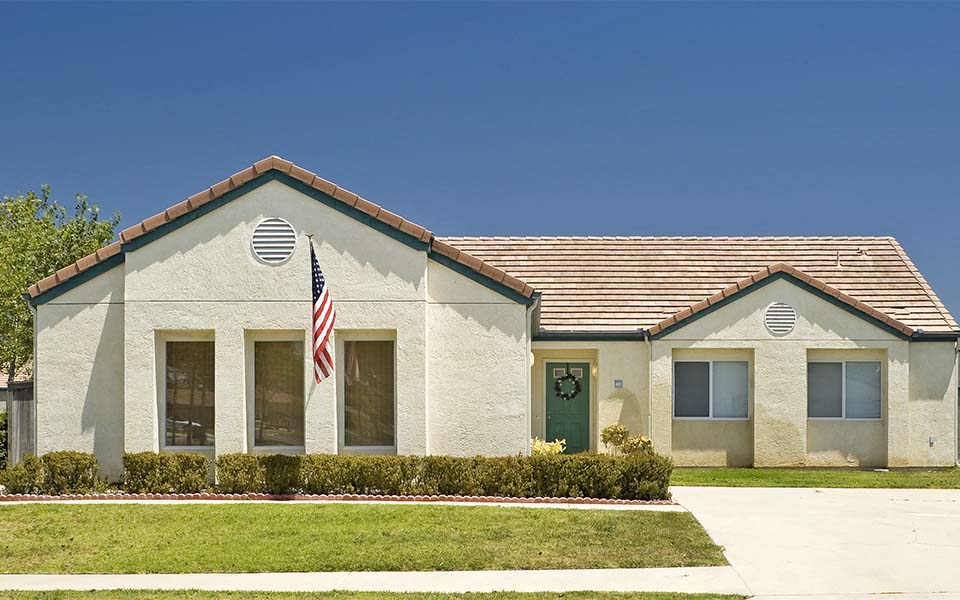 a white house with an flag in front of it