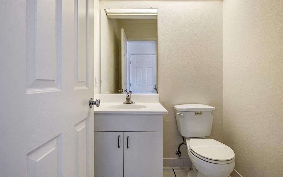 a bathroom with a toilet and a sink and a mirror