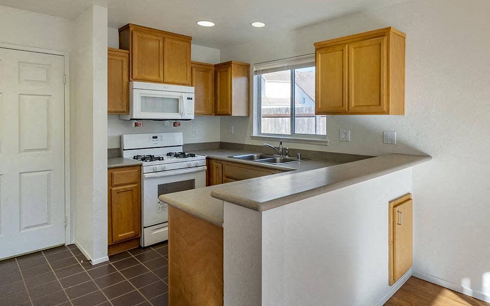 a kitchen with a stove microwave and a sink