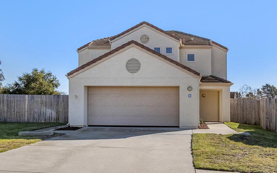 a house with a garage door and a driveway