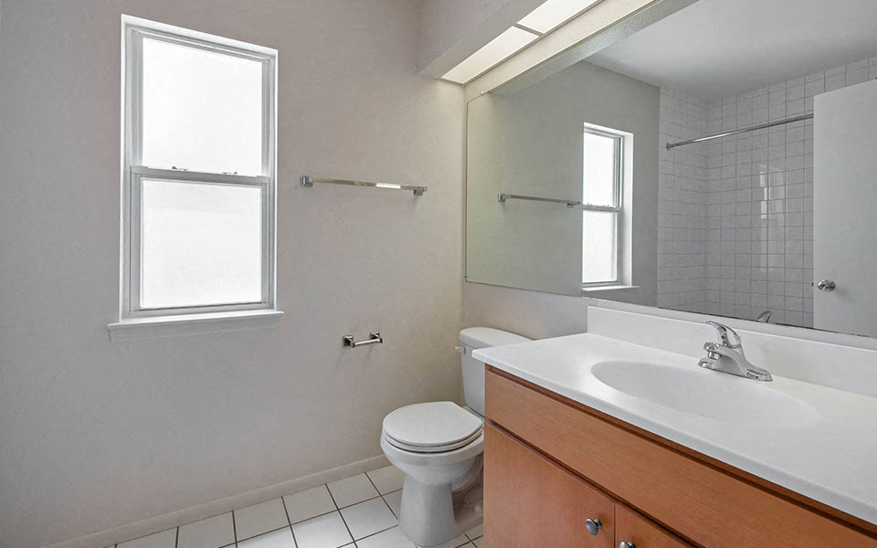 a bathroom with a sink toilet and a mirror