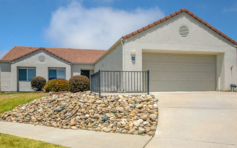 a white house with a driveway and a garage door