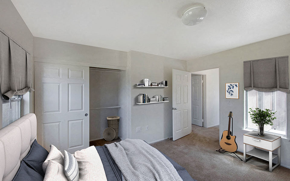 a bedroom with a bed and a guitar in the corner