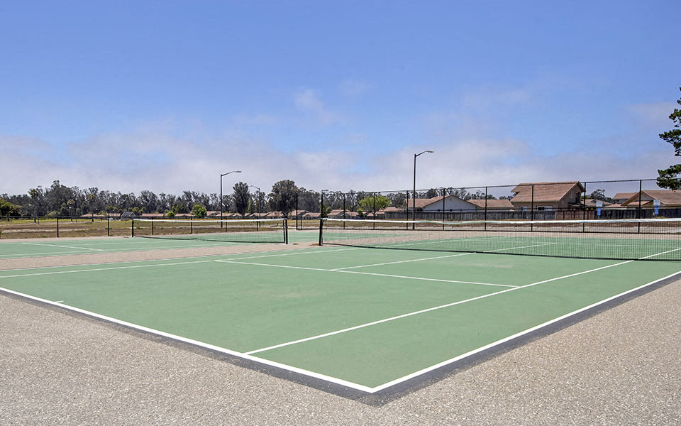 a tennis court with a fence around it