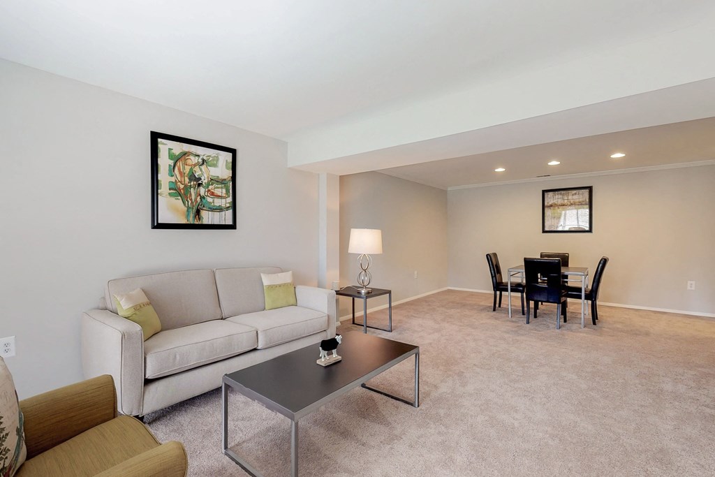 a living room and dining room with a couch and a table