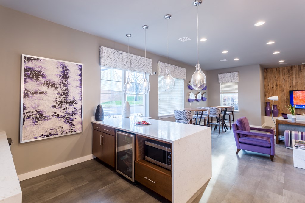 a kitchen with an island and a living room with a dining room