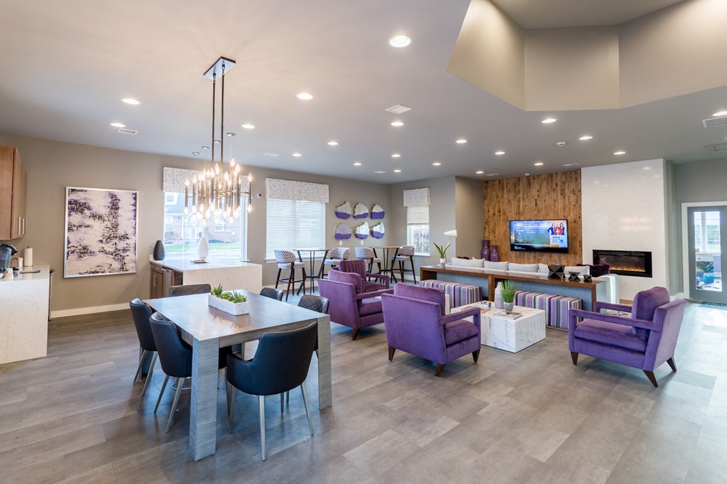 a living room and dining room with purple chairs and a table