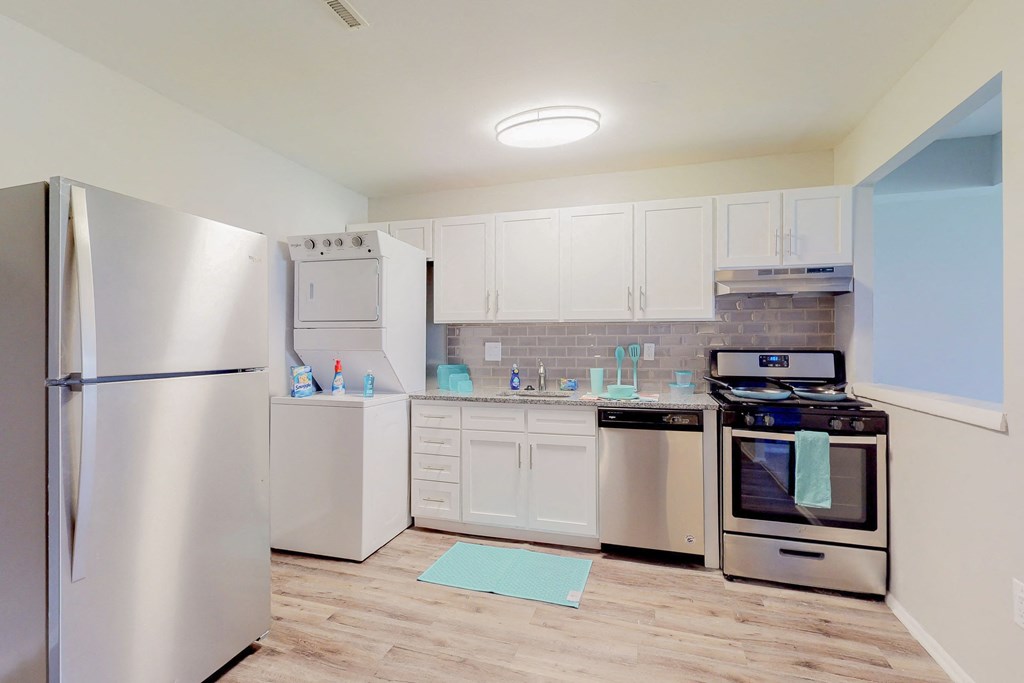 a kitchen with stainless steel appliances and white cabinets