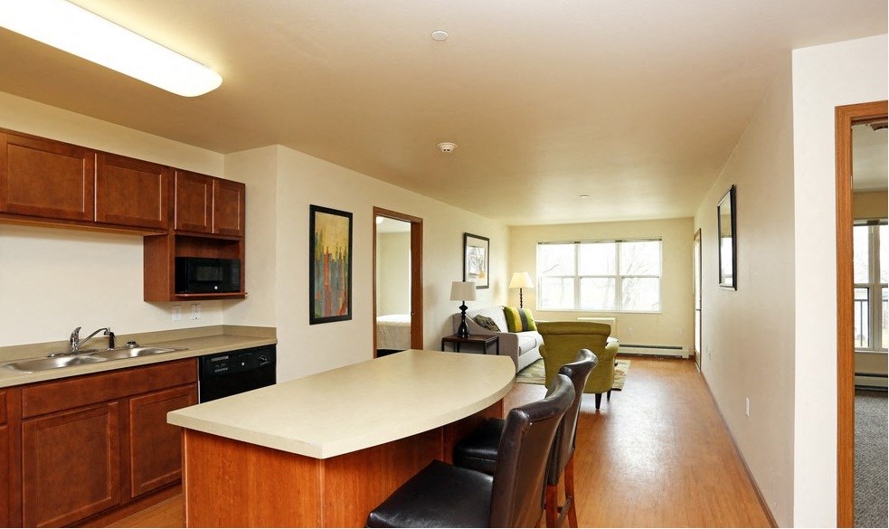 A kitchen with wooden cabinets and a white countertop.