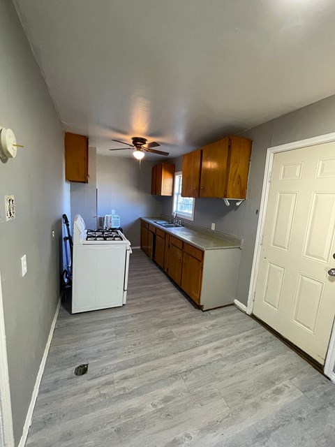 A kitchen with a white fridge and a white stove.