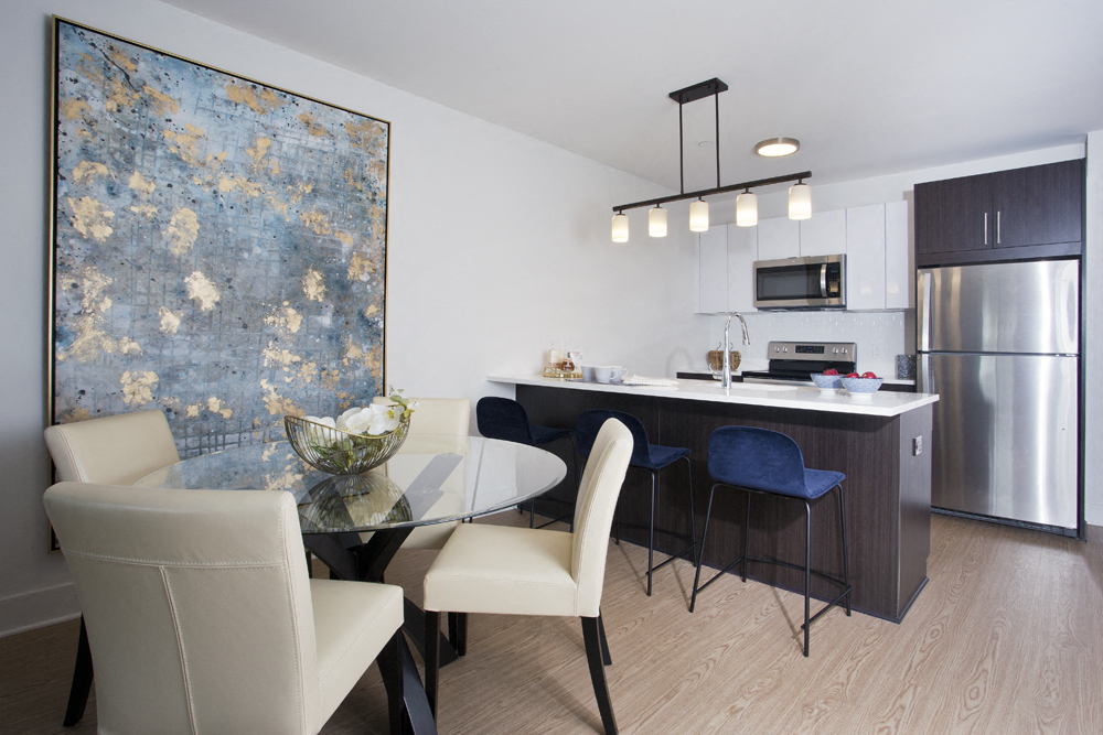 a kitchen and dining room with a glass table and chairs