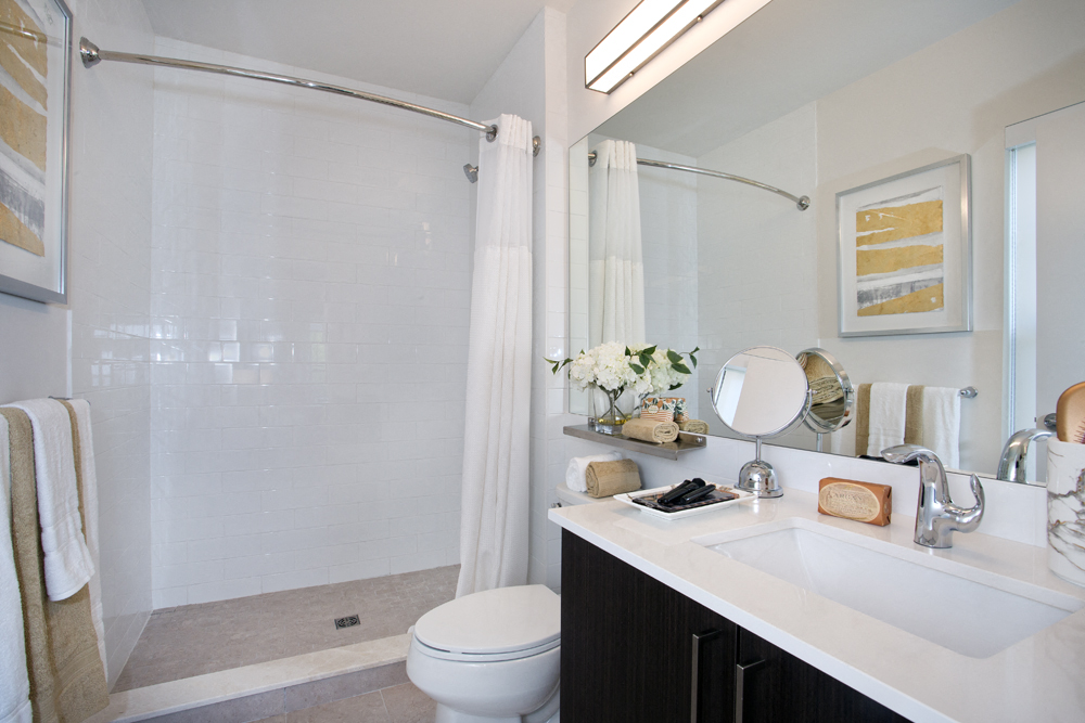 a bathroom with a shower and a sink and a toilet