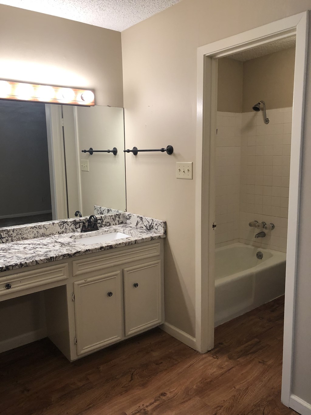 a bathroom with a sink and a tub and a mirror