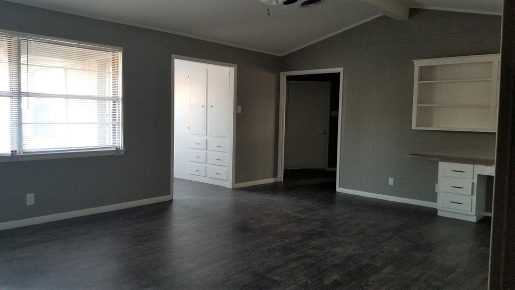 A room with a desk and a window.