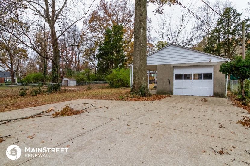 the driveway and garage of a house with a white garage door