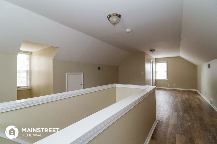 a large empty room with a large ledge and a window