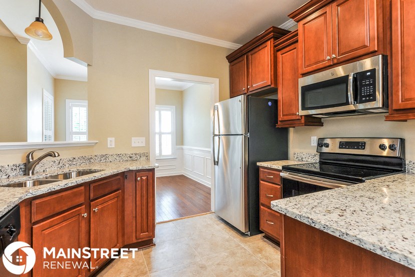 a kitchen with wood cabinets and stainless steel appliances and granite counter tops