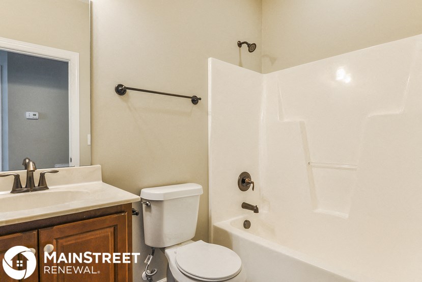 a bathroom with a sink toilet and a tub