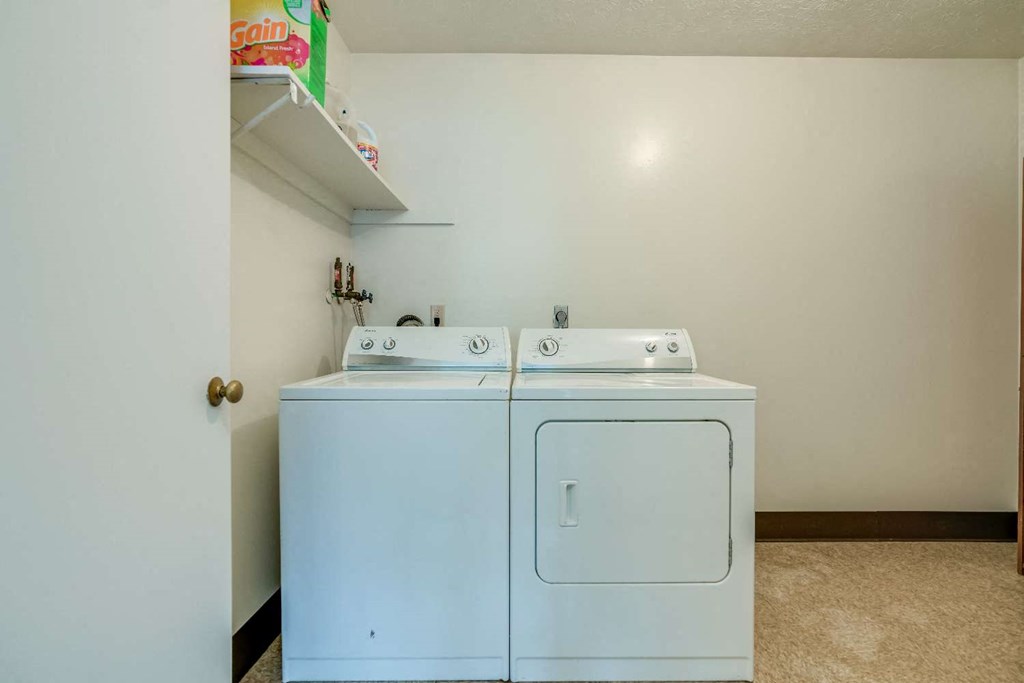 a laundry room with a washer and dryer in it