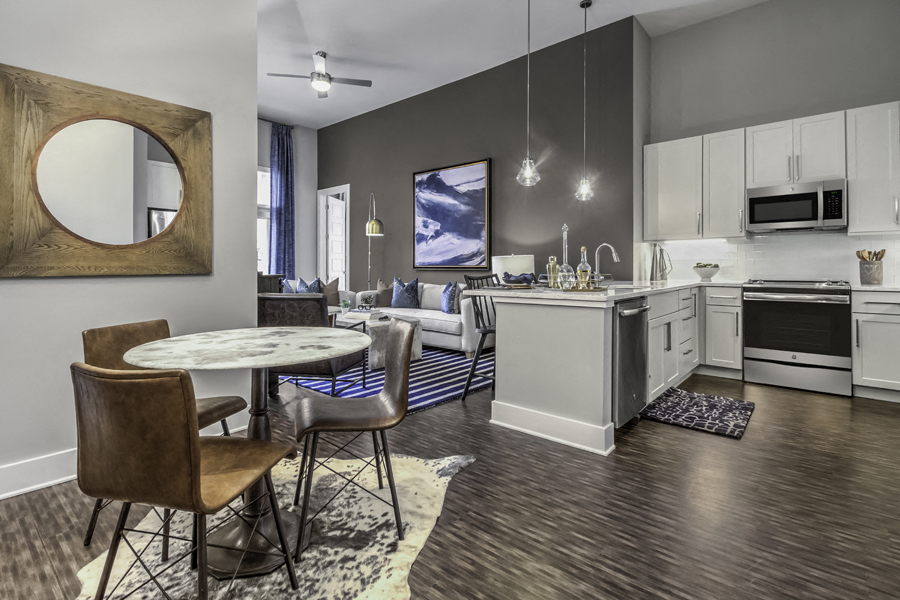 a living room and kitchen with a table and chairs