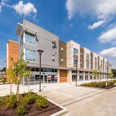 A modern building with a parking lot in front.
