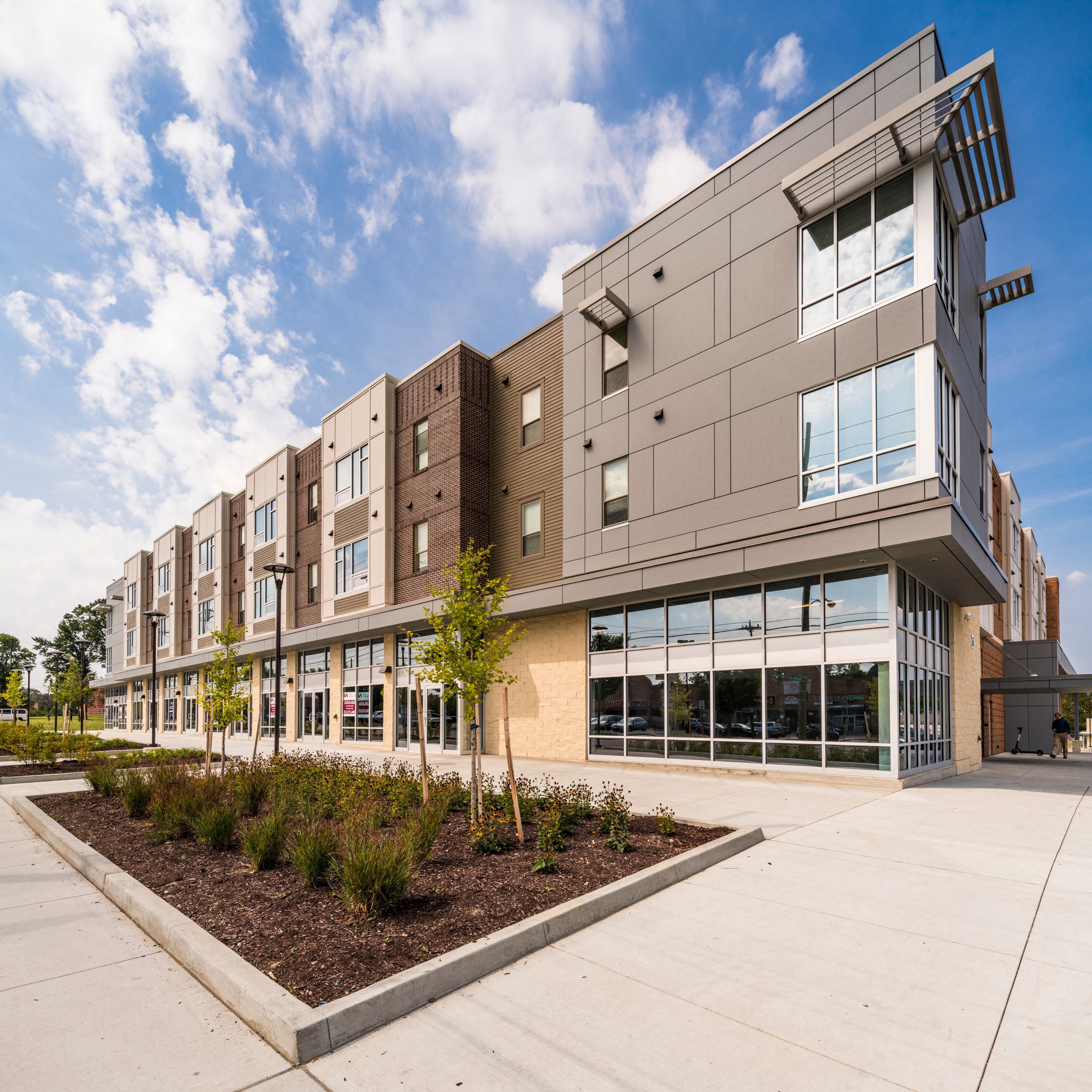 a large building with a sidewalk in front of it