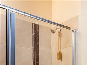 Master bathroom with access to walk-in closet, double vanity and standing shower