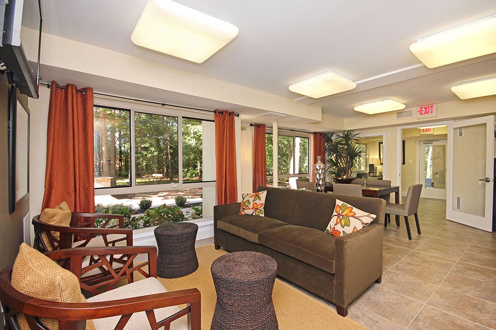 a living room with a couch and a table with chairs
