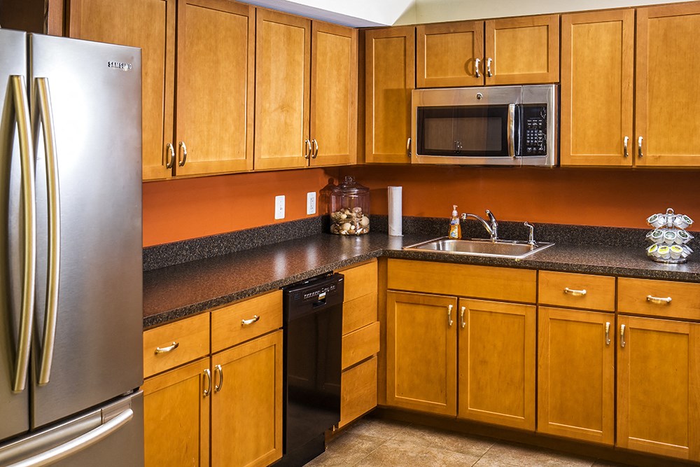 a kitchen with wooden cabinets and stainless steel appliances