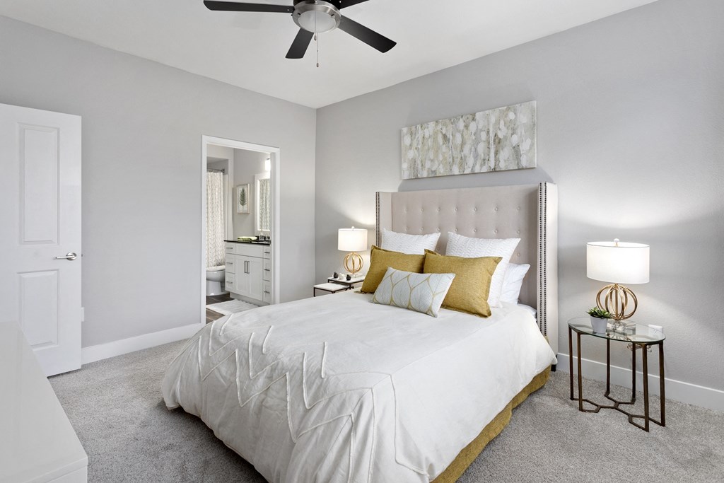 a bedroom with a large bed and a ceiling fan