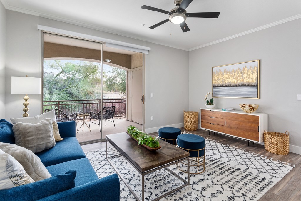 a living room with a couch and a coffee table and a ceiling fan