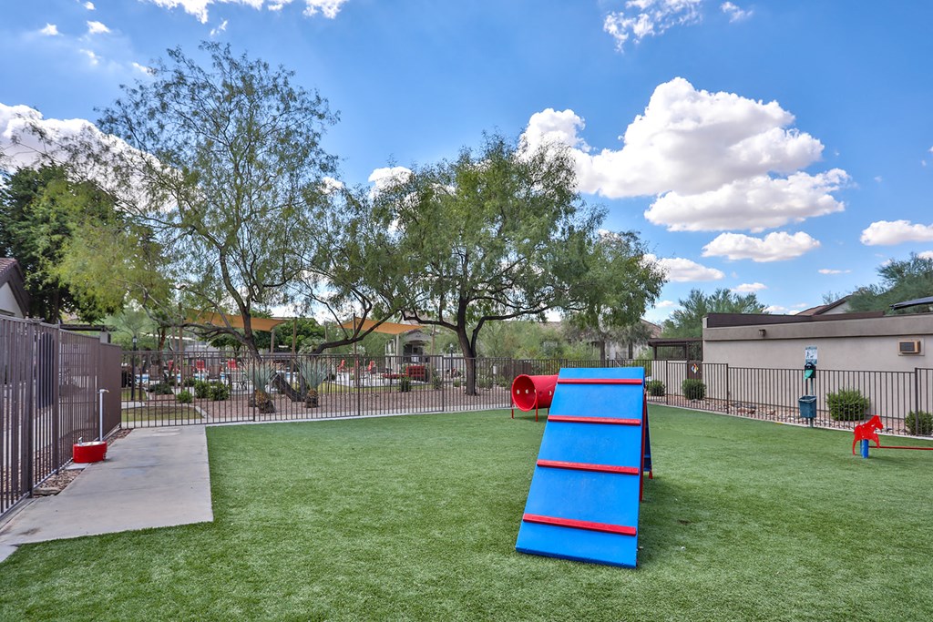 a playground with a seesaw in the middle of the grass