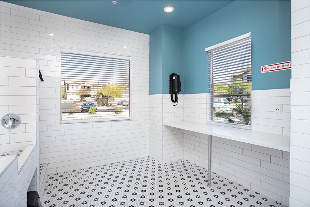 a bathroom with a shower and a sink and a window