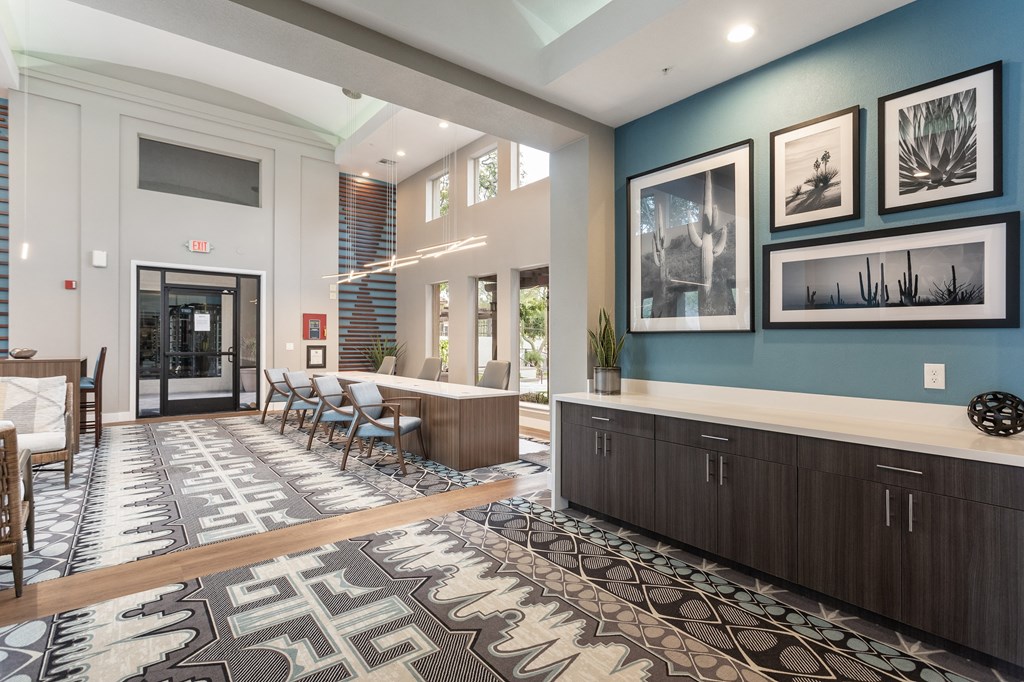 a lobby with chairs and tables and a reception desk