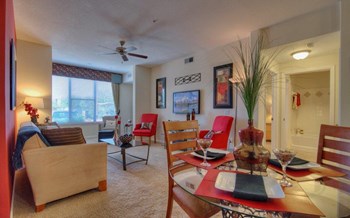 Vue Park West Living Room and dining room with wall to wall carpet and ceiling fan - Photo Gallery 17