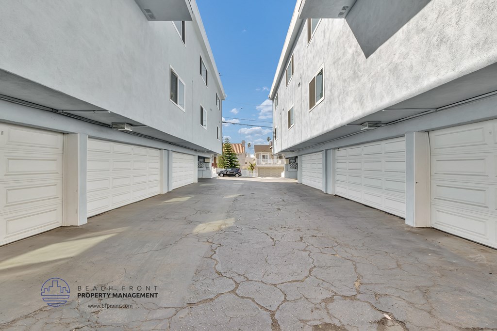 a row of white garages with white shuttered doors