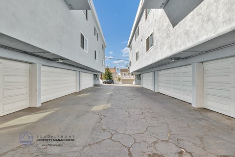 a row of white garages with white shuttered doors