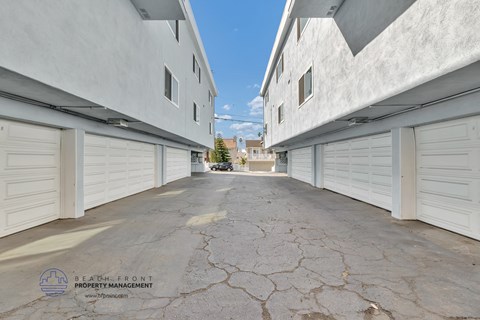 a row of white garages with white shuttered doors