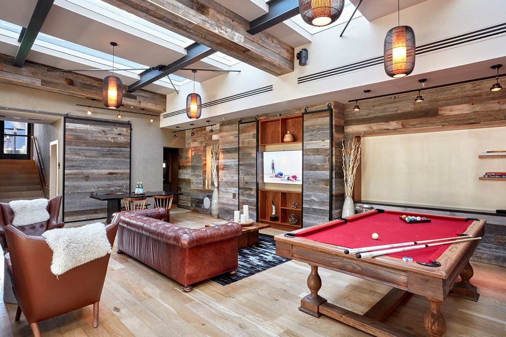a games room with a pool table and a bar