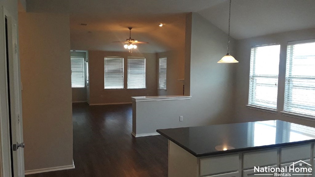 A National Home Rentals interior with a kitchen and living room.