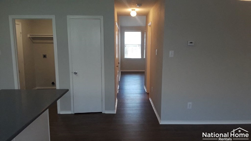 A National Home Rentals image of a room with a door and a window.