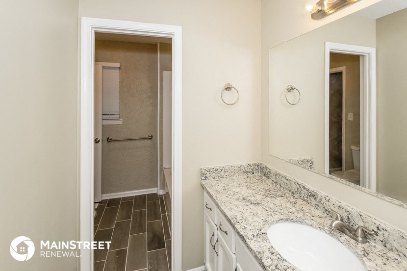a bathroom with a sink and a mirror and a shower