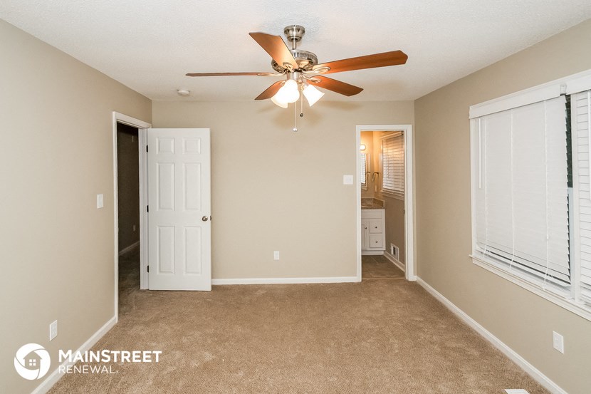 the master bedroom is spacious and has a ceiling fan