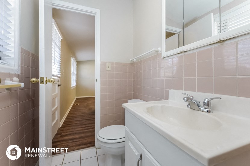a bathroom with a sink and a toilet and a mirror