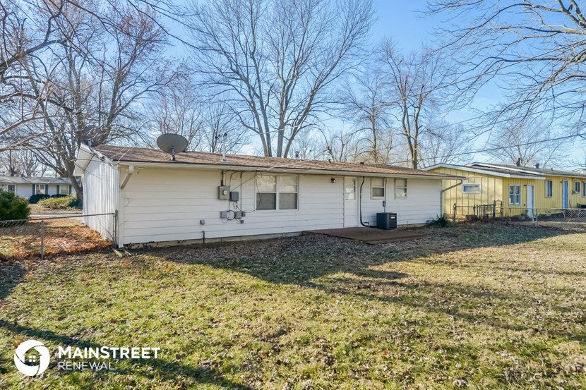 a white house with a yard and some trees