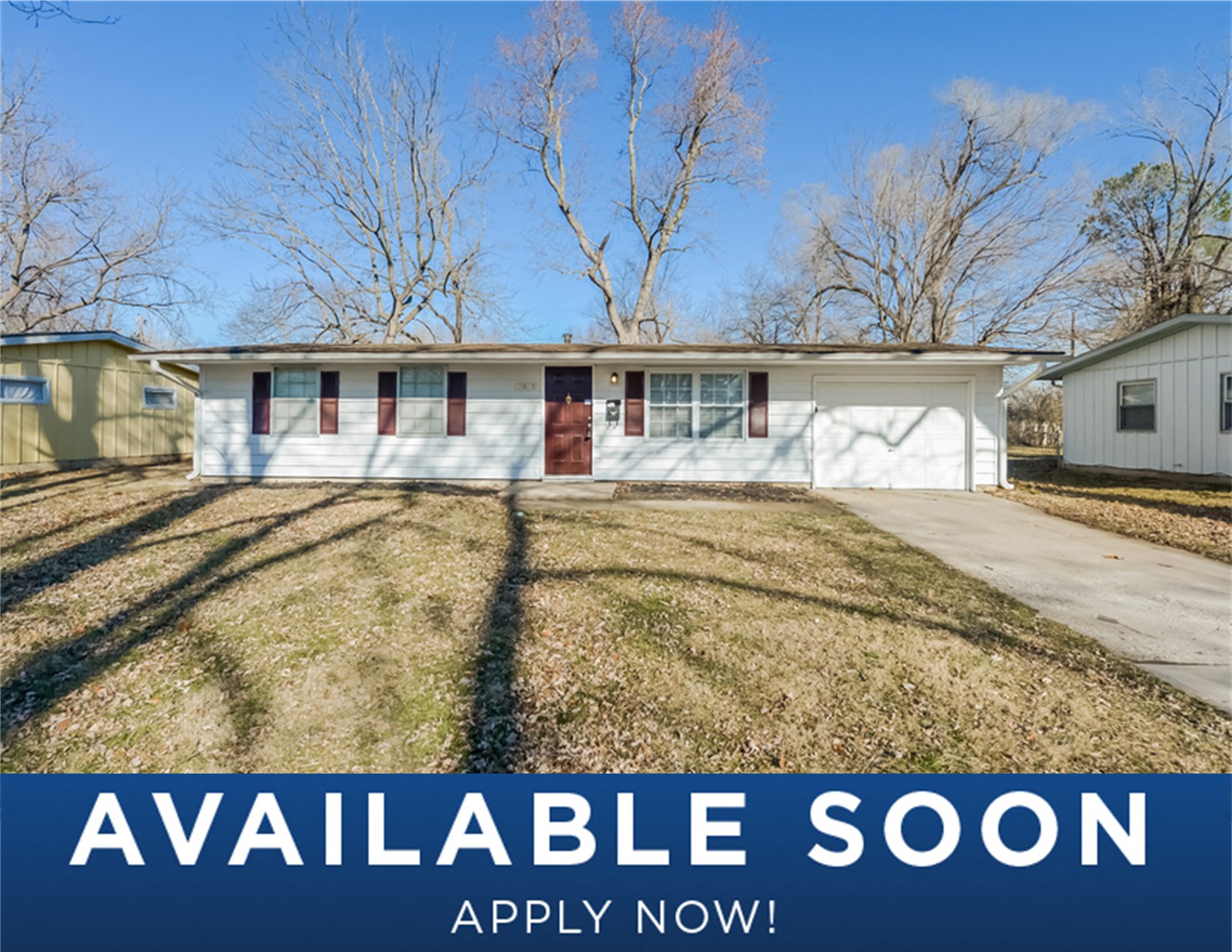 a small white house with a yard in front of it